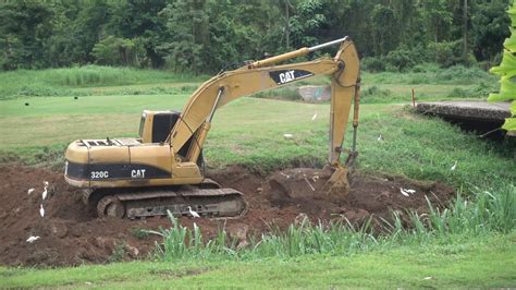 Our fire pit will certainly be constructed as an in ground one. CAT320 Excavator Digging The BIGGEST Rocks - YouTube