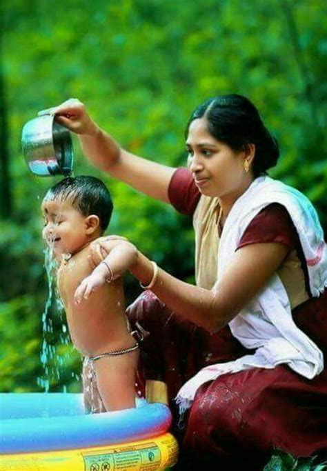 Traditional bathing & massage ritual. Kerala Woman bathing the child | Mother in the private ...