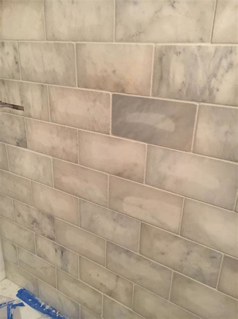 Marble is a metamorphic rock composed of recrystallized carbonate minerals, most commonly calcite or dolomite. What happened to these tiles after grouting?