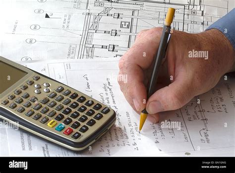 Engineer doing hand calculations on a calculation sheet, with a ...