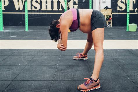 Maybe you would like to learn more about one of these? Pregnant woman bending forward at workout - Stock Photo ...