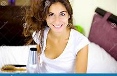 smiling happy hair long drying blow brunette bed cute wind camera looking woman stock