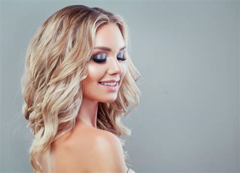 Wavy hair can be refined with a burst fade. Smiling Blonde Woman With Healthy Wavy Hair Stock Image ...