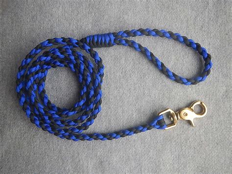 To adjust the length unscrew the solid brass end cap at the end of the wand. Black Acid Blue Paracord Dog Leash from Paracreations USA Hand Braided Custom Dog Leashes