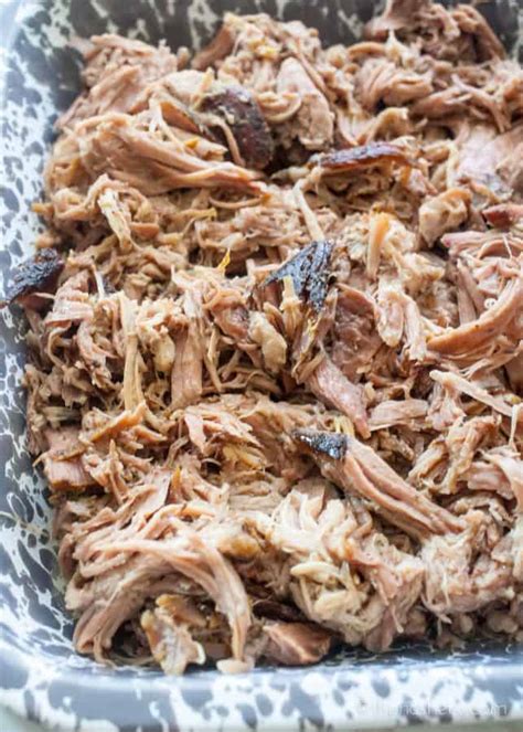 This slow roast pork shoulder cooks for 6 hours, for juicy meat and perfect pork crackling. Slow Cooker Pernil (Puerto Rican Pork Shoulder) | The Noshery