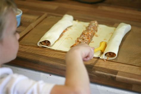 Cut puff pastry into 2 large sheets then assemble brush with olive oil bake at 180 on pre heated oven then enjoy 👌. Homemade puff pastry sausage rolls | Cooking with my kids