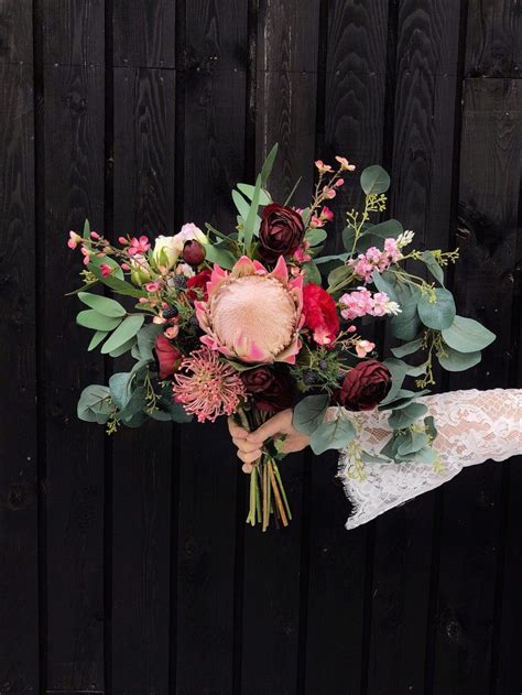 For more inspiration, check out 16 of our favorite ranunculus bouquets here. Protea Wedding Bouquet with Eucalyptus. Burgundy Bouquet ...