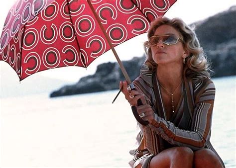 It strands two unattractive characters the problem with the madonna character is that she starts out so hateful that she can never really. Madonna (in Missoni & holding a Chanel umbrella) filming ...