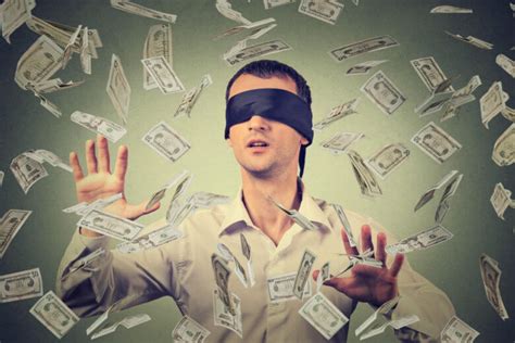 Wake up and fuck, scyley jam. Blindfolded young businessman trying to catch dollar bills ...