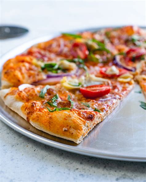 Use your hands to carefully place the dough on a pizza peel spread. Thin Crust Pizza Dough (with Video!) | Recipe in 2020 ...