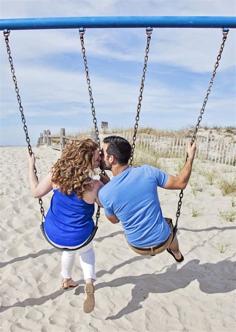 Best match | most recent. Happy Couple on swing set stock image. Image of adults ...