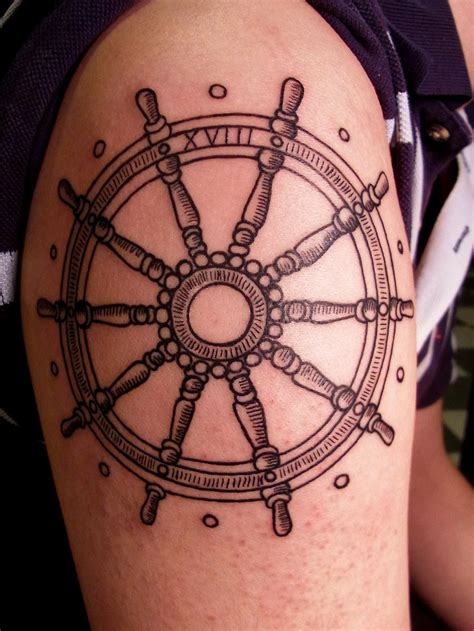 This set of tattoos uses black, gray, and white to compose images depicting a ship wheel and anchor surrounded by quotes. ship wheel | Cécile Pagès | Flickr