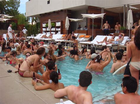 Several boys and girls are playing at a pool in their swimming suits. Bare Pool @ The Mirage | Lauren Smith | Flickr