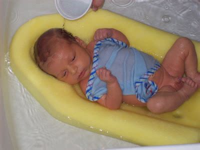 Continue supporting your baby's head and back as needed. Bohlen Family: First bath.