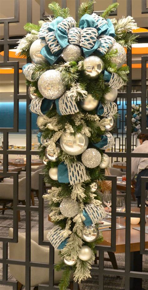 At christmas central, we offer these swags in a variety of different styles and sizes to suit your decorating needs. silver and teal blue decorated christmas swag rental ...