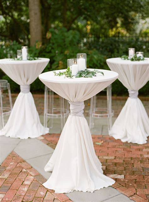 Check out this white pillar candles and greenery atop cocktail tables and see more inspirational photos on theknot.com. White Pillar Candles and Greenery Atop Cocktail Tables in ...