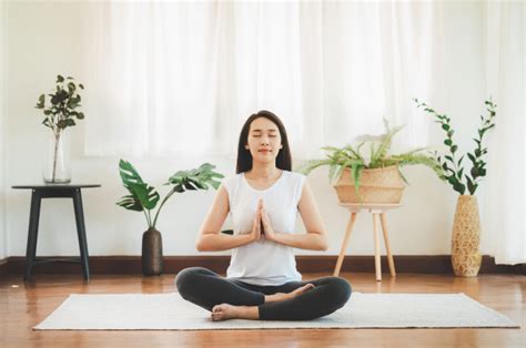 Ich möchte mit dem meditieren anfangen aber weiß nicht wo man das am besten macht? Asiatische frau, die yoga meditation zu hause tut ...