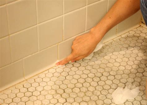 It is probably mildew, and the best way to remove it is a.g. Learn How to Re-Caulk Your Bathroom | how-tos | DIY