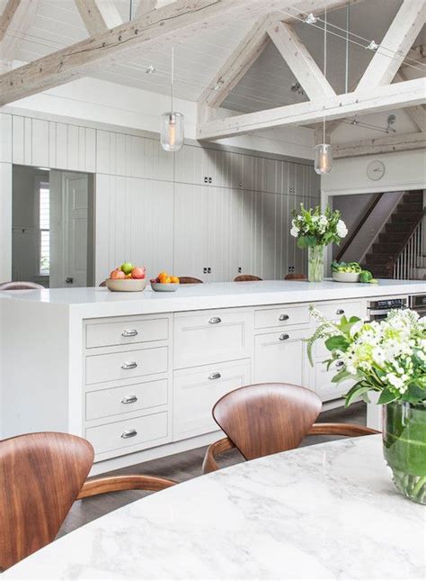 Whitewashed ceiling beams blend into the white backdrop of the bedroom with ease. Open plan kitchen with whitewashed truss ceilings beams ...