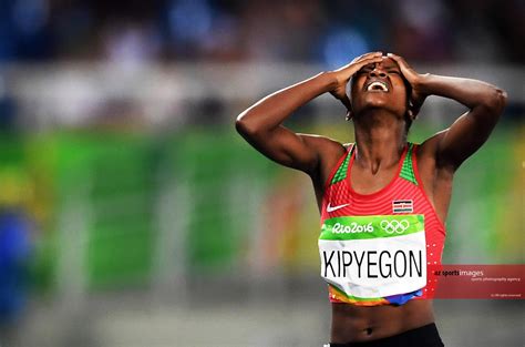 Faith chepngetich kipyegon of kenya celebrates with the flag of kenya after winning the gold medal in the women's 1500m final on day 11 of the rio. azsportsimages | KIPYEGON Faith Chepngetich