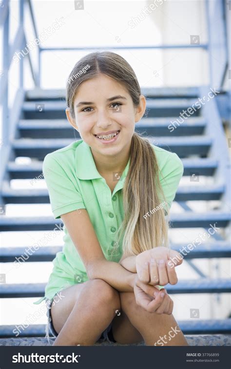 Our collection boasts hundreds of images. Portrait Of Smiling Tween Girl Sitting On Stairway Stock ...