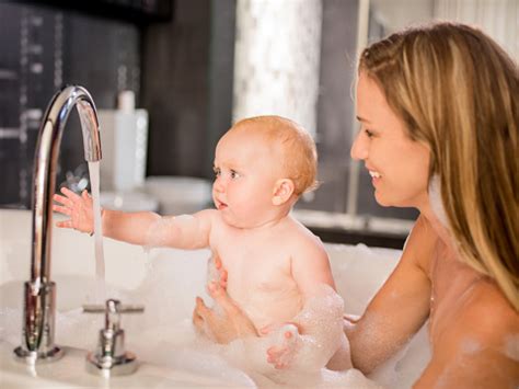 Although you just cleaned your baby using the. Modern Mom Takes Bubble Bath With Infant Daughter Stock ...