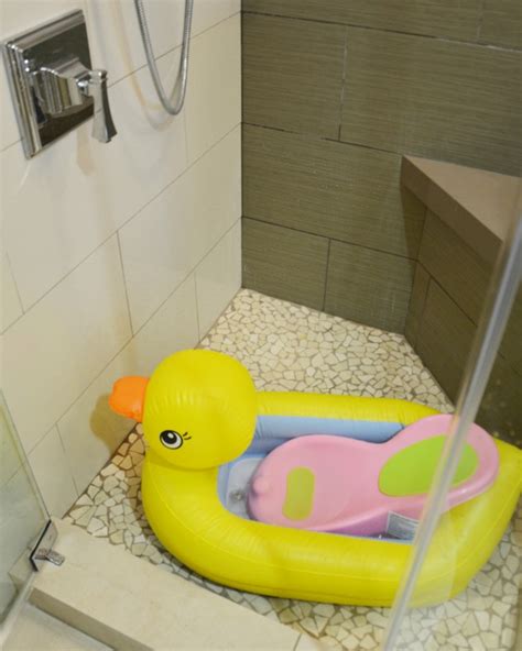 A baby bathtub will help you prop up a wriggling newborn. Traveling with baby: how to bath a baby in a room without ...