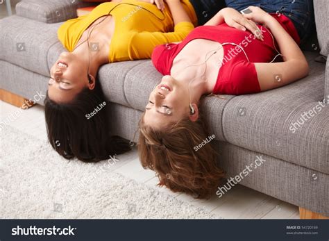 Family laying down in snow. Happy Teen Girls Lying On Couch Stock Photo (Edit Now ...