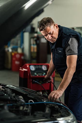 This is especially a possibility if the air has gradually gotten warmer over a few weeks or if you're turning your a/c back on after not using it over the winter. Auto Mechanic Checking Car Air Conditioning System In A ...