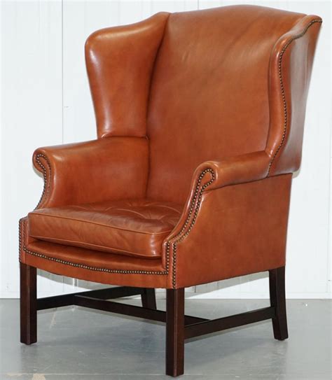 Custom made in a selection of over 100 premium leathers. Wingback Brown Leather Armchair Floating Button ...