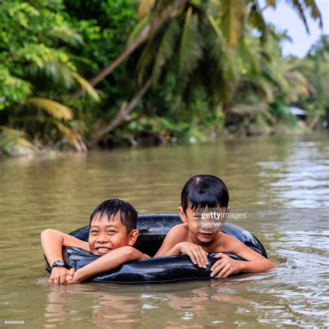 two-little-vietnamese-boys-bathing-in-mekong-river-delta-vietnam-high