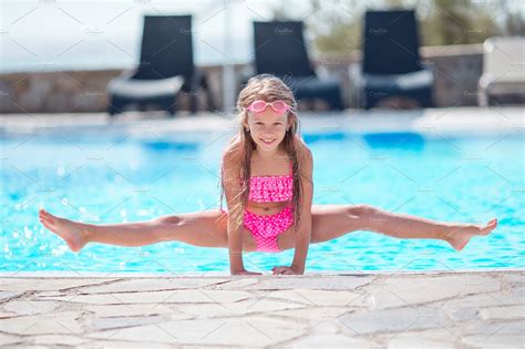 Make a splash at campsites with swimming pools outdoors. Little happy girl in outdoor swimming pool enjoy her ...