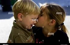 brother sister kissing baby alamy