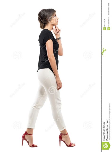 Profile view of young indian woman standing while thinking with body facing the camera against white background. Side View Of Young Business Woman In Suit Thinking And ...