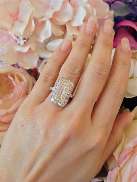 Speak with our jewelry specialists online. GIA 4.41 Carat Emerald Cut Fancy Light Yellow Diamond Gold Platinum Halo Ring at 1stdibs