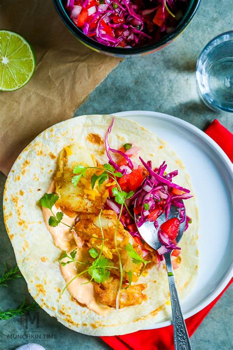 These baja fish tacos are cocooned in a warm corn tortilla garnished with crunchy cabbage, fresh pico de gallo, and creamy white sauce all finished with you are going to love how easy this baja fish tacos recipe is and bonus, almost all the components can be prepped and refrigerated beforehand. Beer Battered Baja Fish Tacos Recipe - Munchkin Time