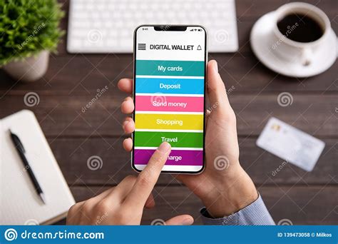 Digital wallets function as means of storage for personal and payment information that is encrypted for security. Man Holding Smartphone With Digital Wallet Application ...