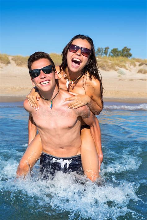 These teen couples in animated shows prove that love comes in many forms, as well as art forms. Teen Couple Enjoying Piggyback On Summer Beach Stock Image ...