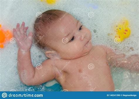 Some parents and caregivers continue to use basin tubs even after baby is sitting up. Cute 4 Months Old Baby Boy Having A Bath With Foam Stock ...