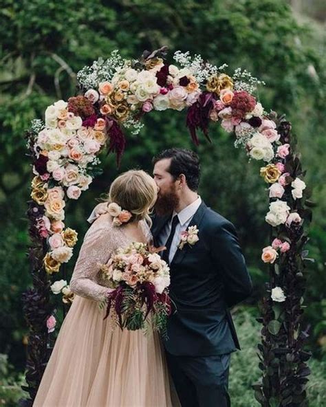 Secure the flowers even if they are indoors so they don't get bumped and creative wedding arch with ladders, burgundy fabric, pretty blooms and greenery with ombre red. 28 Refined Burgundy And Blush Wedding Ideas - Weddingomania