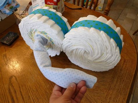 Next, wrap four more diapers around it. How to Make a Diaper Motorcycle Baby Shower Show Stopper ...