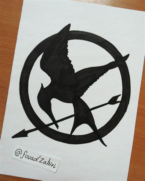 The hunger games logo burns bright. Hunger Games Logo