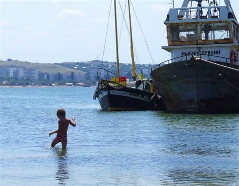 Yellow sand, green sea water and cloudy sky background. A Boy Of Azov Sea | This photo was shot in Mysovoye, near ...