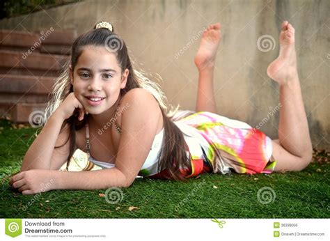 Using a hair tie, put the rest of your hair in a low ponytail. Teenage Girl Lying Down In The Grass Stock Photo - Image ...