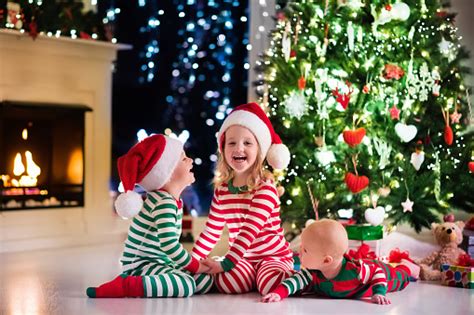 We spoke with two interior designers on how to avoid the constant. Kids In Pajamas Under Christmas Tree In Decorated Living ...