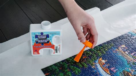 The easiest way to glue your puzzle is to actually pour the glue right on top of the puzzle and then use a piece of cardboard or a business card to spread the glue around. How To Mount a Finished Jigsaw Puzzle - Mom Always Finds Out