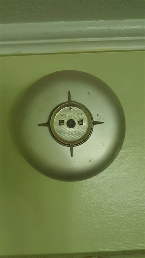 Although a smoke alarm and a smoke detector are two different devices, identical installation / location rules apply to both of them. I believe this is an old smoke detector from a house built ...