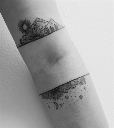 Visualize the design on your arm, taking into consideration whether wrapping it around the side will distort the perspective. Bicep and forearm landscape tattoos.