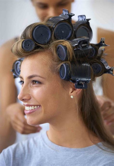 Spend $20 get a $5 gift card on select beauty care items. How to use hot rollers. Model with rollers in her hair ...