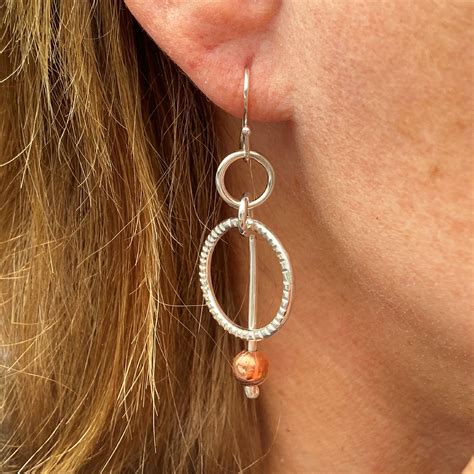 Finally, mix things up with the innovative modern design of our thread thru earrings. Handmade sterling silver and copper circle dangling ...